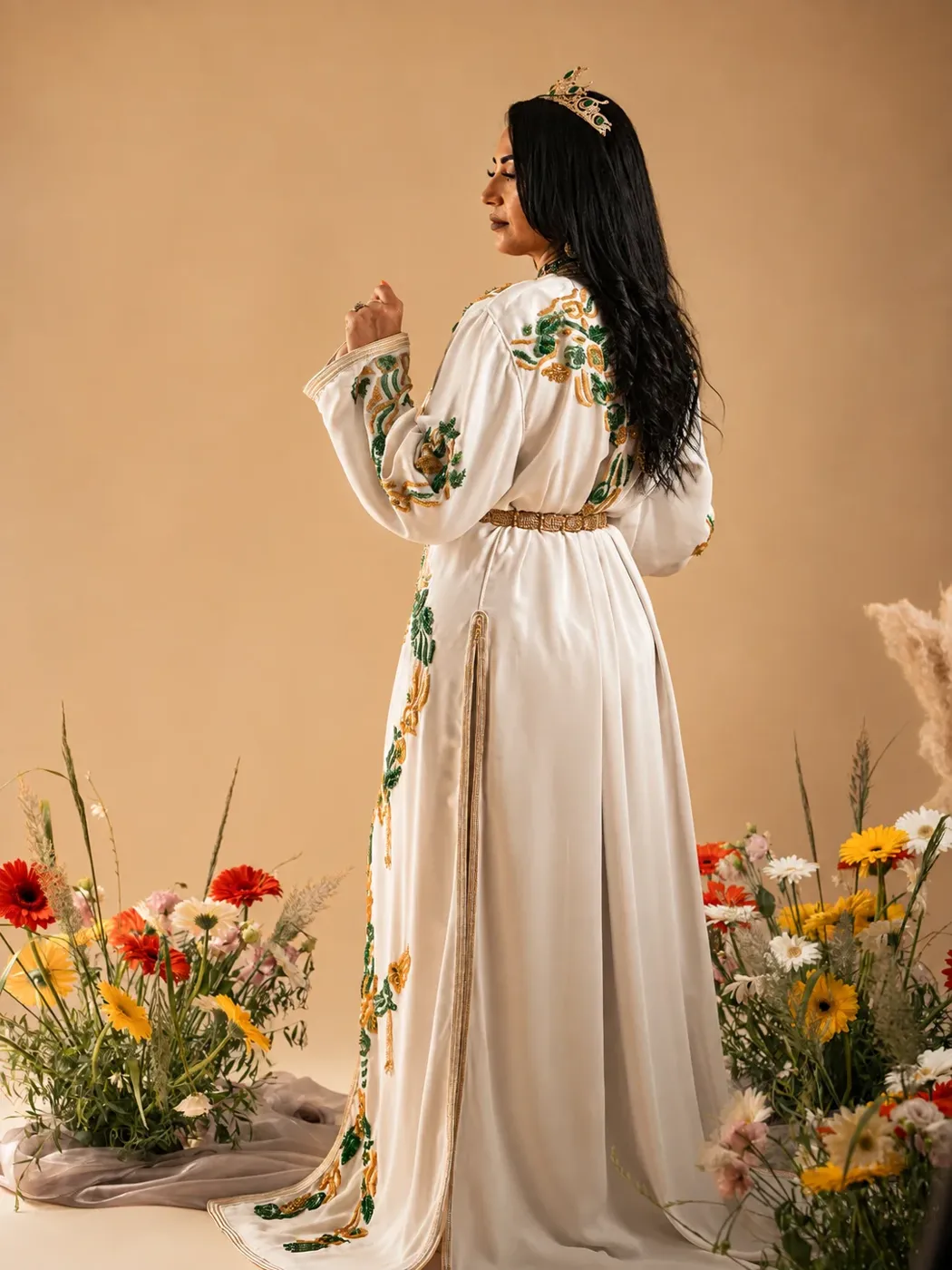 Mariée en caftan blanc dans une mise en scène florale réalisée avec un fleuriste